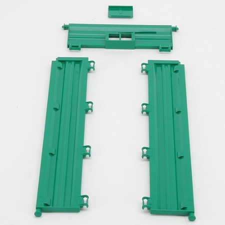 Ground side plates for tandem axle trailer